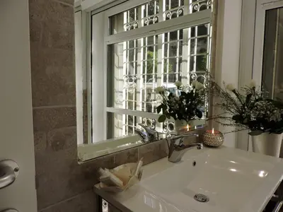 a bathroom with a sink and a window at Anfiteatro Suite in Rome