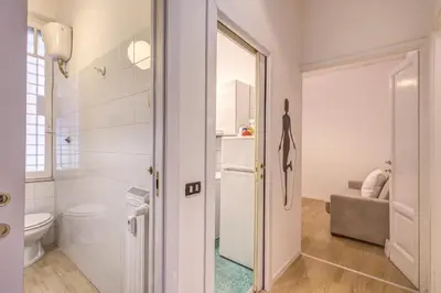a white bathroom with a toilet and a sink at M&L Apartment - Caracalla Holiday in Rome