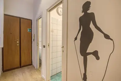 a mural of a woman on a wall in a hallway at M&L Apartment - Caracalla Holiday in Rome