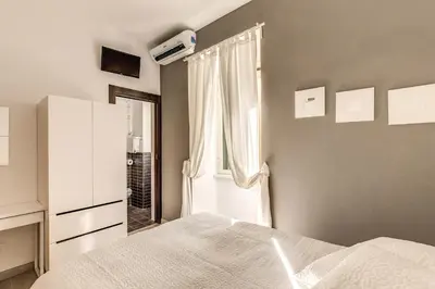 a bedroom with a bed and a window at M&L Apartment - Caracalla Holiday in Rome