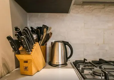 a kitchen counter with a knife block and a tea kettle at Casa Oliva in Rome