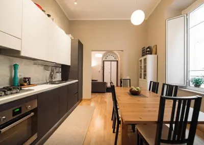 a kitchen and dining room with a table and chairs at Casa Oliva in Rome