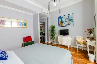 a bedroom with a bed and a desk and a computer at Athena Guest House in Rome