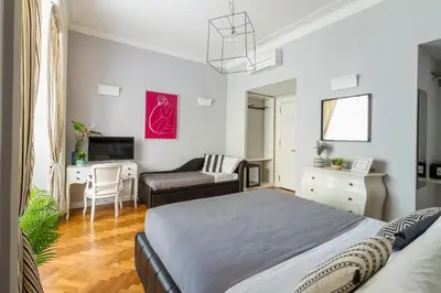 a bedroom with a bed and a living room at Athena Guest House in Rome