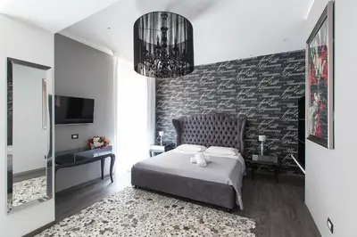 a bedroom with a bed and a chandelier at Town House Roma in Rome