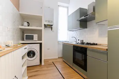 a kitchen with a washing machine and a washer at Stazione Vaticana 5 Apartment in Rome