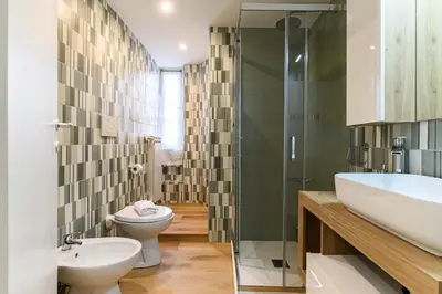 a bathroom with a toilet and a sink and a shower at Stazione Vaticana 5 Apartment in Rome