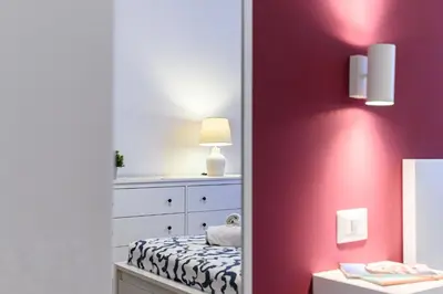 a bedroom with a dresser and a mirror at Stazione Vaticana 5 Apartment in Rome