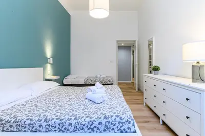 a bedroom with a bed with a teddy bear on it at Stazione Vaticana 5 Apartment in Rome