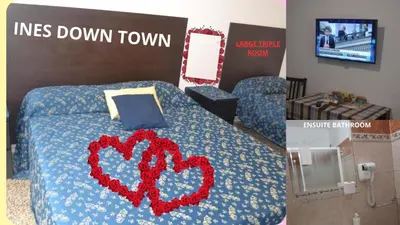 a room with a bed with a heart sign on it at Ines Downtown B&B in Rome
