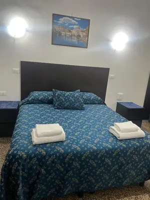 a bedroom with a bed with two towels on it at Ines Downtown B&B in Rome
