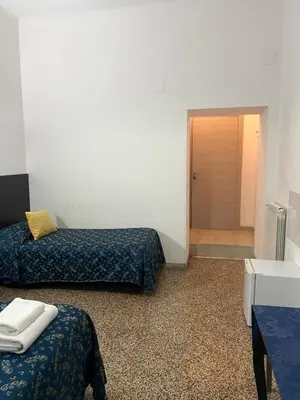 a room with two beds and a walk in shower at Ines Downtown B&B in Rome