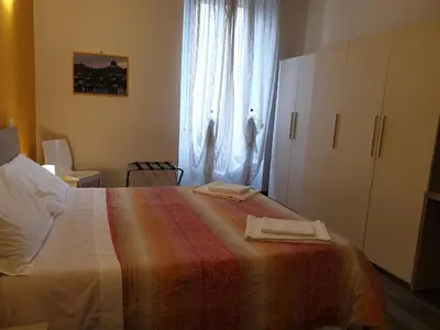 a bedroom with a bed with two towels on it at Holidays in Rome - Guesthouse in Rome