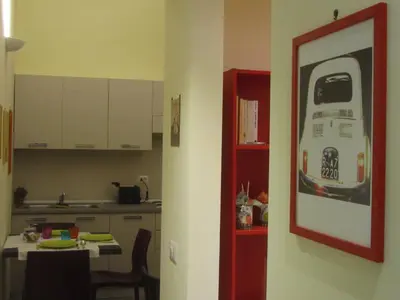 a kitchen with a picture of a bus on the wall at Holidays in Rome - Guesthouse in Rome