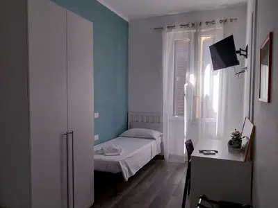 a small bedroom with a bed and a window at Holidays in Rome - Guesthouse in Rome