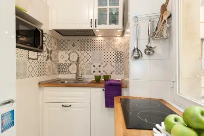 a kitchen with white cabinets and a sink at FL Apartments Charming Flat in the heart of Trastevere in Rome