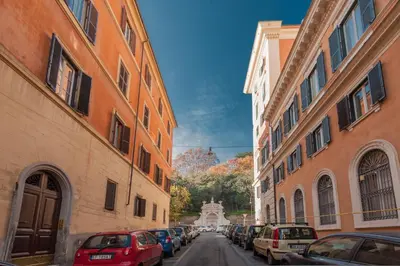 an alley with cars parked on a street between two buildings at FL Apartments Charming Flat in the heart of Trastevere in Rome