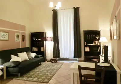 a living room with a black couch and a chair at Magenta Collection Del Grande in Rome