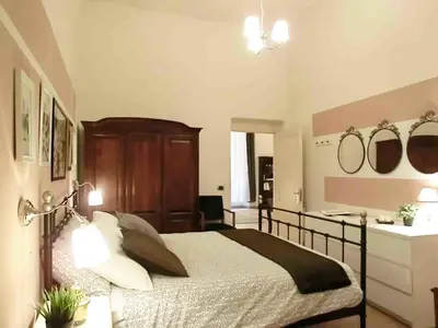 a bedroom with a bed and a desk with mirrors at Magenta Collection Del Grande in Rome