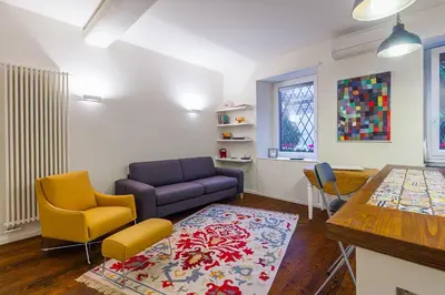 a living room with a couch and chairs and a table at Wake At Rome in Rome