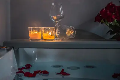 a table with a glass of wine and two candles at New Design St.Peter in Rome