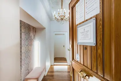 a hallway with a chandelier and a wooden door at New Design St.Peter in Rome
