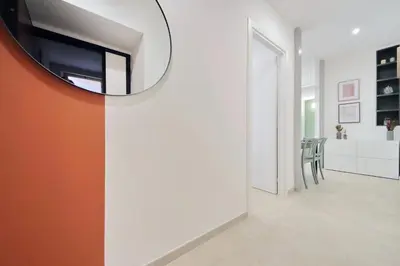 a living room with a mirror on the wall at Nancy Bleisure Suite by DomusDimore in Rome
