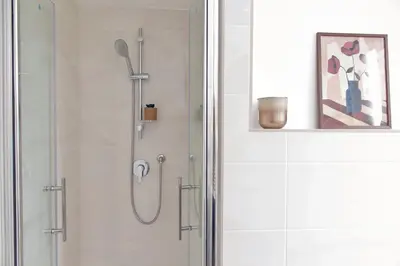 a shower in a bathroom with a glass door at Nancy Bleisure Suite by DomusDimore in Rome