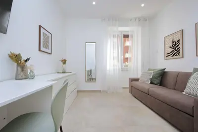 a living room with a couch and a mirror at Nancy Bleisure Suite by DomusDimore in Rome