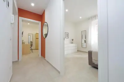 a bedroom with white walls and a mirror and a bed at Nancy Bleisure Suite by DomusDimore in Rome