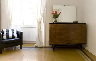 a room with a dresser and a chair and a mirror at Domus Farnese in Rome
