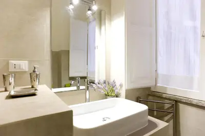 a bathroom with a white sink and a mirror at Domus Farnese in Rome