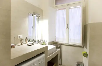 a bathroom with a sink and a mirror and a window at Domus Farnese in Rome