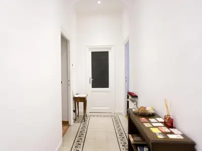 a hallway with a door and a table at Domus Farnese in Rome