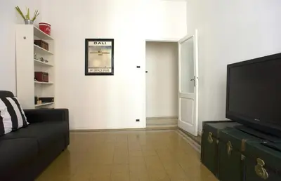 a living room with a couch and a flat screen tv at Domus Farnese in Rome