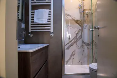 a bathroom with a sink and a shower at Rome Armony Suites in Rome