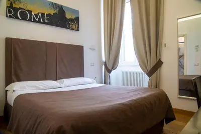 a bedroom with a bed and a window at Rome Armony Suites in Rome