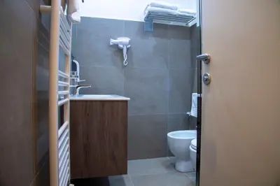 a small bathroom with a sink and a toilet at Rome Armony Suites in Rome