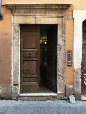 an entrance to a building with two wooden doors at Piazza Farnese in Rome
