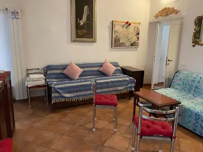 a living room with a couch and a table and chairs at Piazza Farnese in Rome