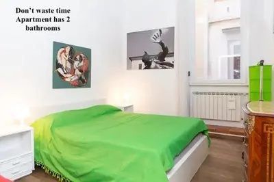 a bedroom with a green blanket on a bed at Piazza Farnese in Rome