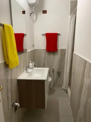 a bathroom with a sink and a red towel at Piazza Farnese in Rome