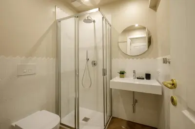 a bathroom with a shower and a toilet and a sink at Daplace - La Locanda di Piazza del Popolo in Rome