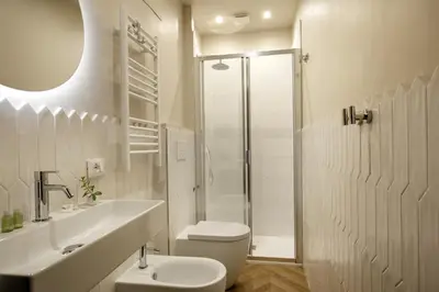a white bathroom with a toilet and a shower at Daplace - La Locanda di Piazza del Popolo in Rome