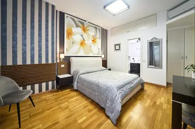 a bedroom with a purple bed and a window at Astoria Golden House in Rome