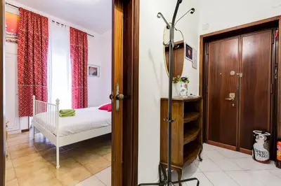 a small bedroom with a bed and a crib at Casa Vacanza Home Sweet Home di Fatha in Rome