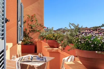 a table and chairs on a balcony with potted plants at Le case di Andrea - Roof Suite Rome in Rome