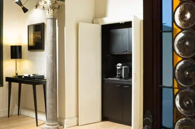 a room with a pillar and a kitchen with a microwave at Le case di Andrea - Roof Suite Rome in Rome