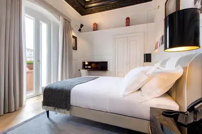 a bedroom with a bed and a tv on a wall at Le case di Andrea - Roof Suite Rome in Rome