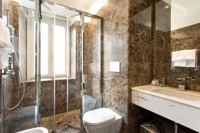 a bathroom with a shower and a toilet and a sink at Le case di Andrea - Roof Suite Rome in Rome